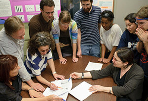People around a table looking at papers