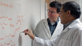 Scientists writing on a whiteboard